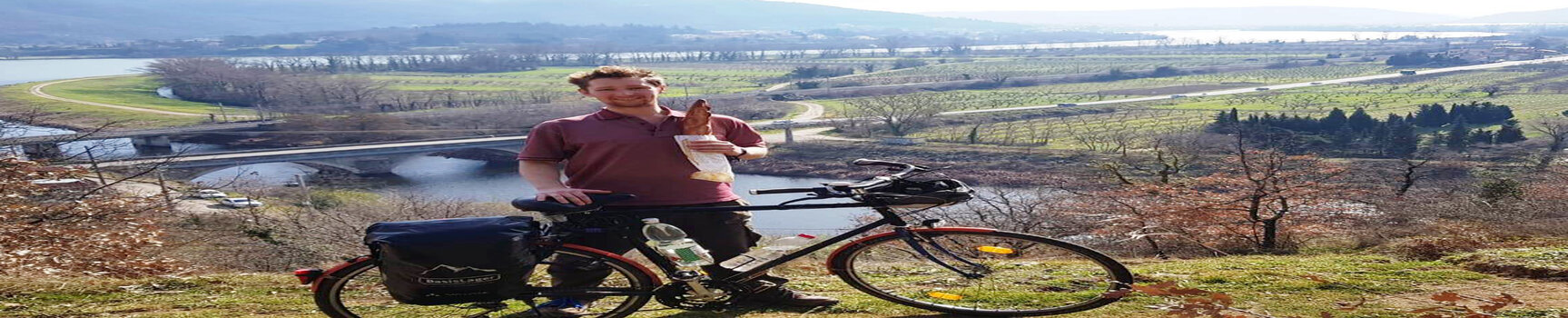 Kalvin a student from Australia with his bike in front of mountains in Switzerland