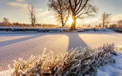 Dawn over the river in winter morning