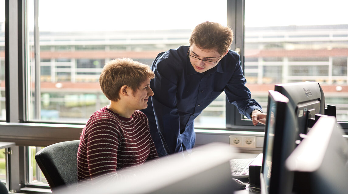 Zwei Studierende arbeiten gemeinsam am Computer.