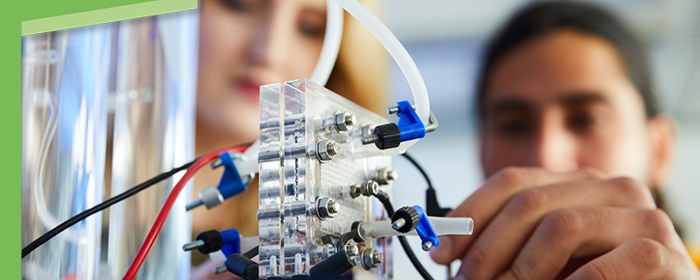 Zwei Studierende bauen am Modell eines Wasserstoffmotors