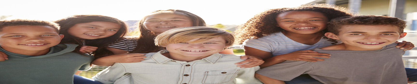 Elementary school kids smiling to camera during school break