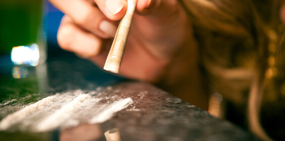 Young woman snorting cocaine