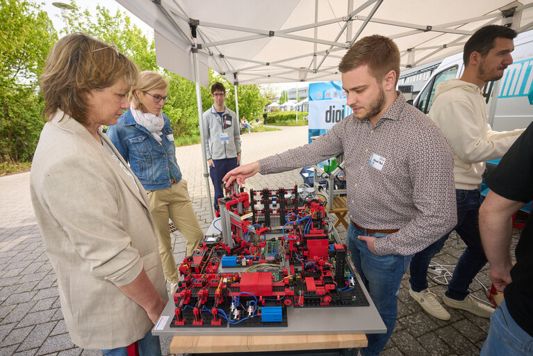 Infostand mit Menschen und technischen Geräten