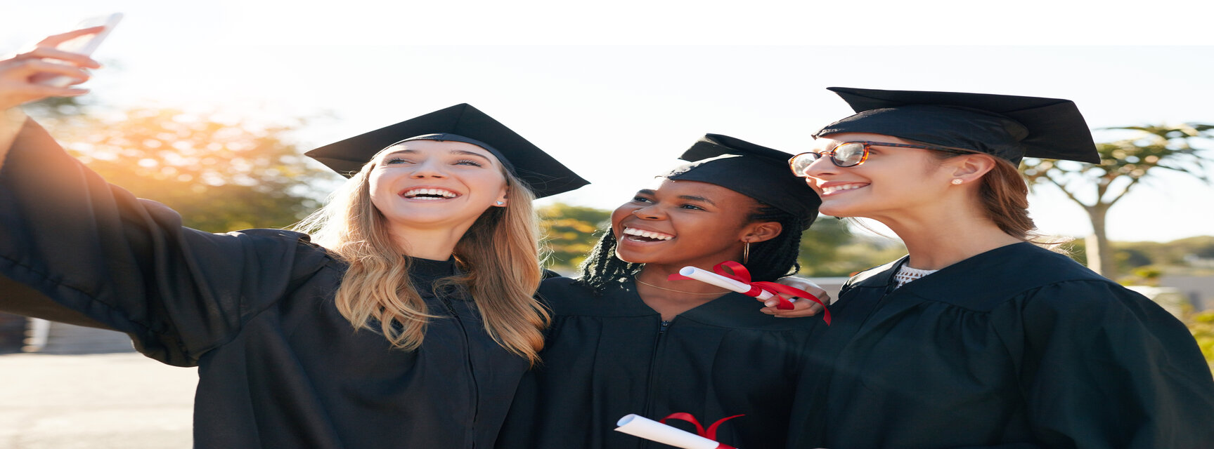 Friends, students and graduation selfie with college or university women together with a smile. People outdoor to celebrate education achievement, success and future at event for school graduates