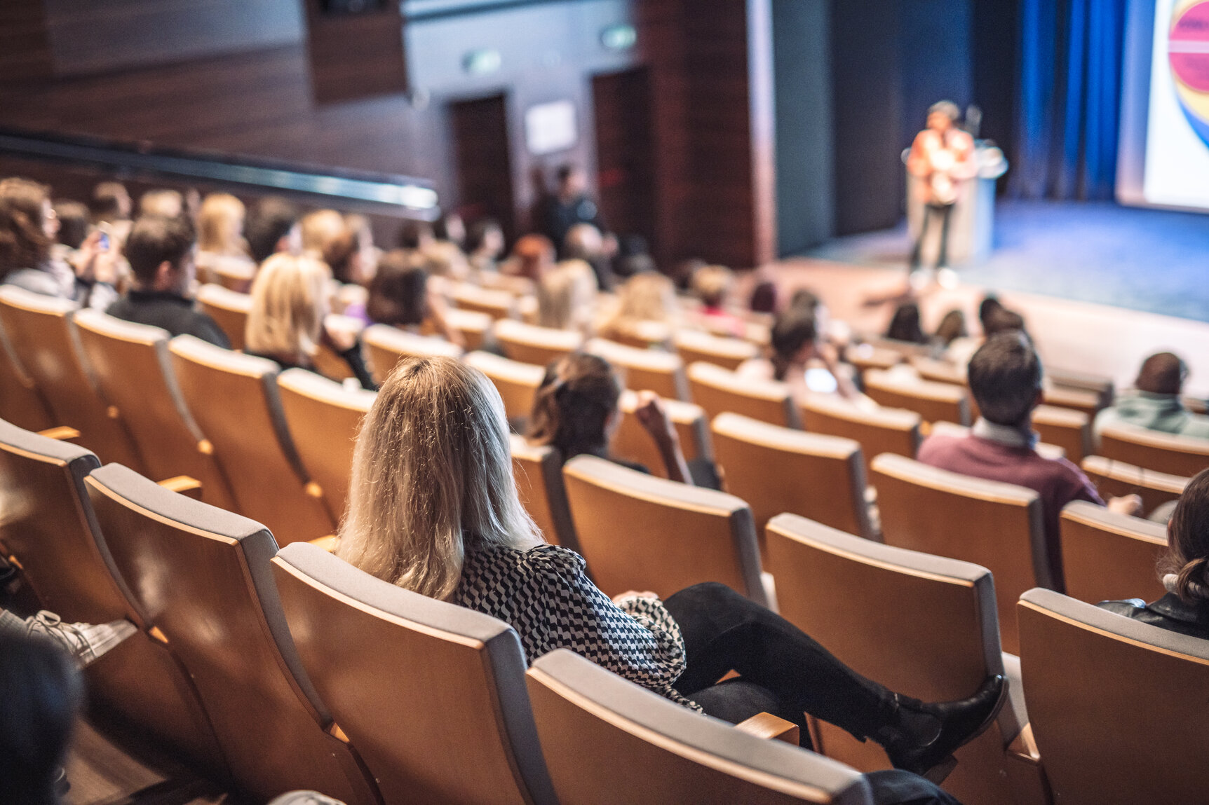 Woman giving presentation on business conference event.