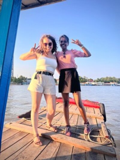 two students in front of a lake