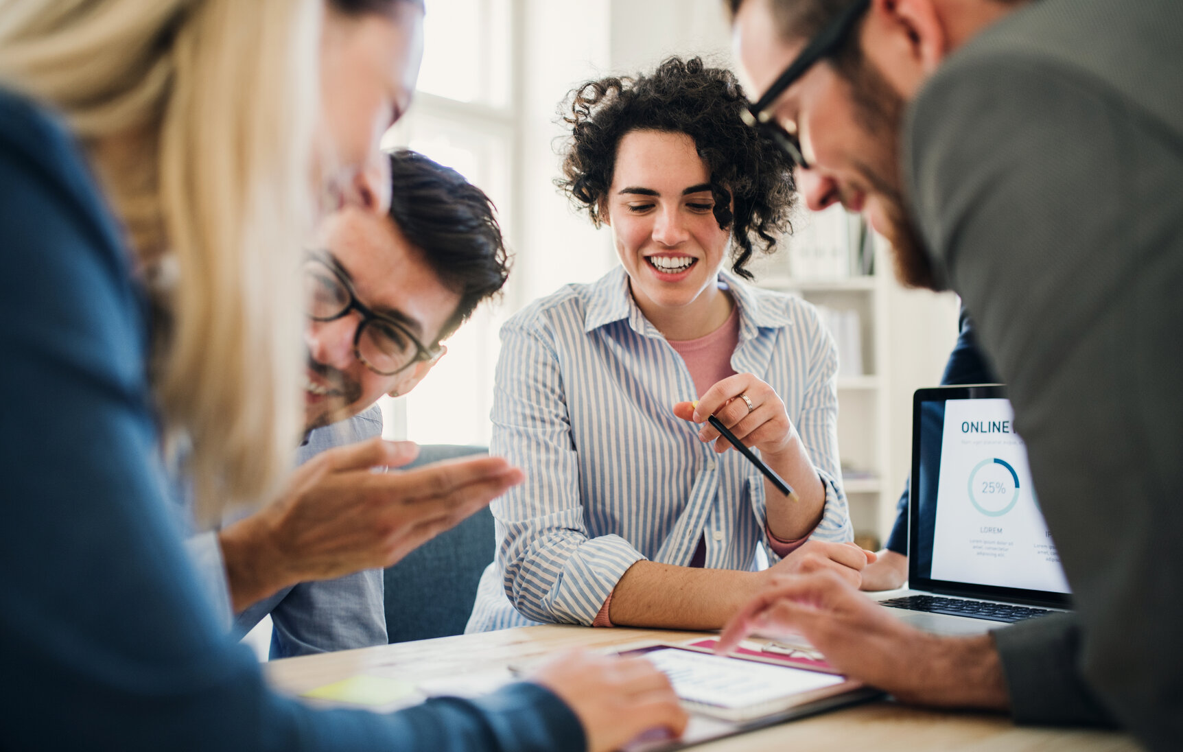 Group of young businesspeople with laptop working together in a modern office. Group of young businesspeople with laptop working together in a modern office.