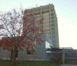 Brock University building, tree and bench.